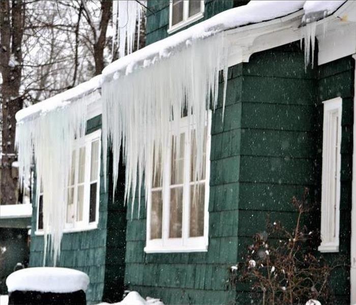 Icicles hanging from the gutters of a house.